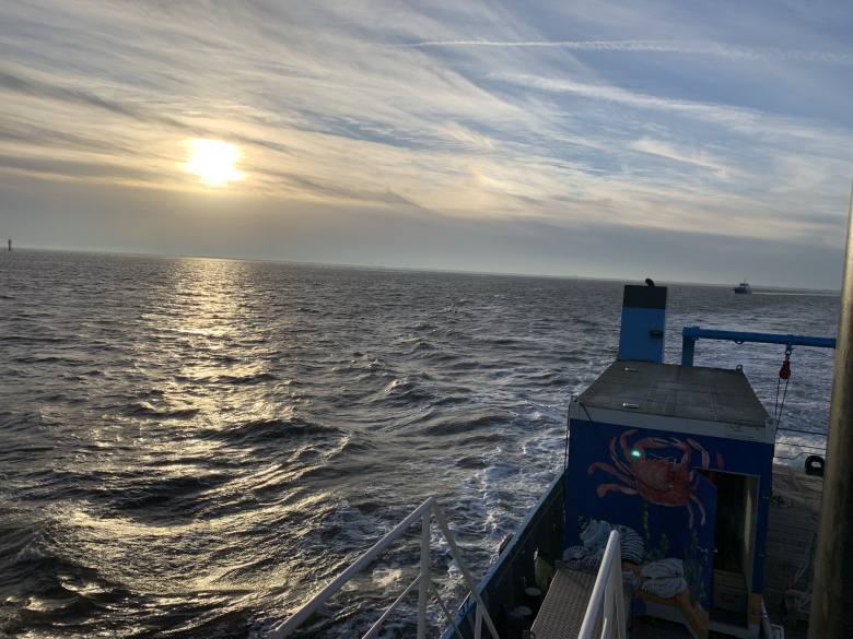 Sunrise over the North Sea with vessel